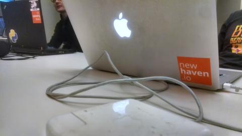 Back of laptop with a sticker that reads “new haven.io”