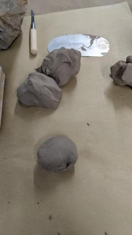 Balls of clay,  cutting tool, and a metal rib