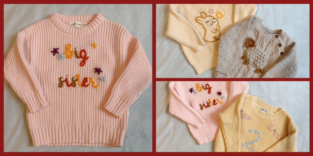 A light pink knit sweater with the words "big sister" embroidered in colorful yarn, shown alongside other knit sweaters featuring designs like a bunny, a bear, and the number "2."